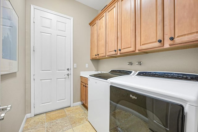 washroom featuring washer and dryer and cabinets