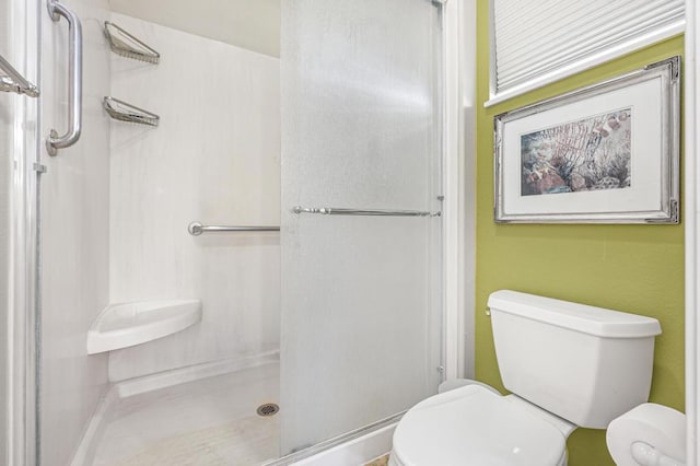 bathroom featuring a shower and toilet