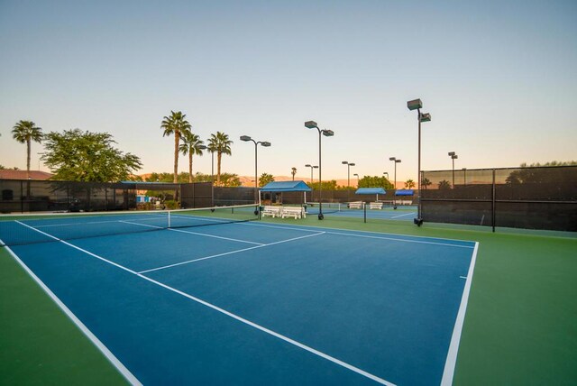 view of tennis court with basketball hoop