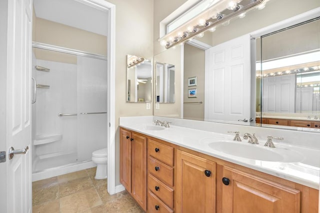 bathroom featuring toilet, an enclosed shower, and vanity