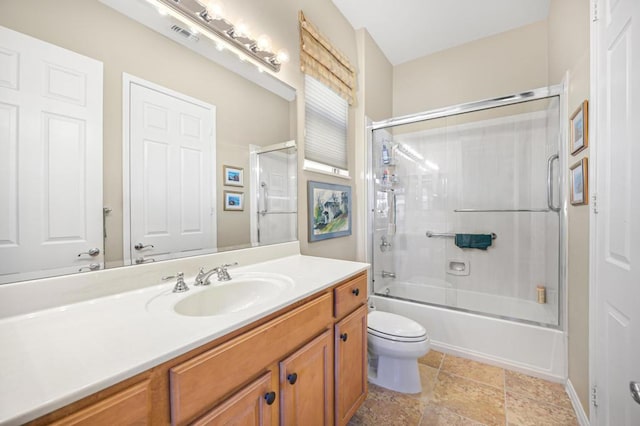 full bathroom with toilet, combined bath / shower with glass door, and vanity