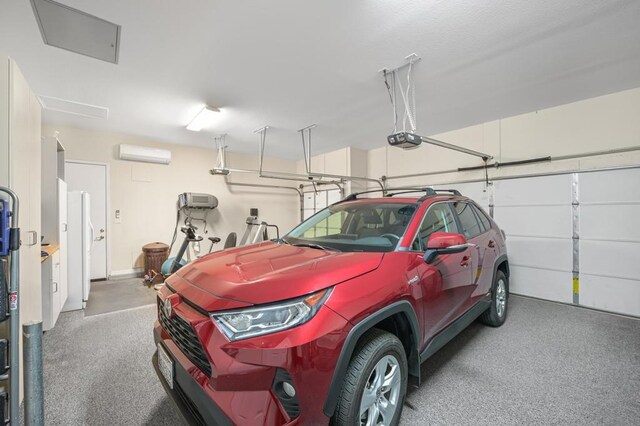 garage featuring white fridge, a garage door opener, and a wall mounted air conditioner