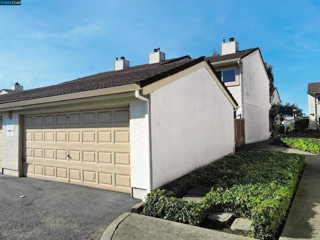 view of side of property with a garage