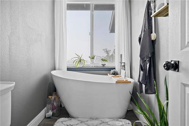 bathroom with a tub to relax in