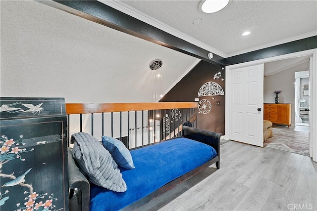 bedroom with vaulted ceiling with beams, crown molding, hardwood / wood-style floors, and a textured ceiling