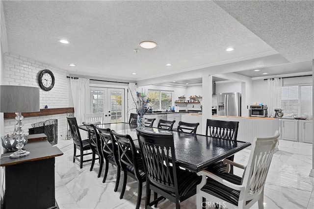 2052 Thomas Pl, West Covina, CA 91792 - dining area featuring light marble finish floors, a textured ceiling, a brick fireplace, french doors, and recessed lighting