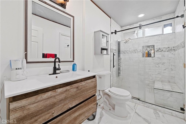 bathroom featuring vanity, a shower with shower door, and toilet