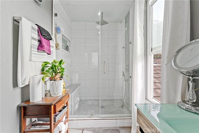 bathroom featuring vanity and an enclosed shower