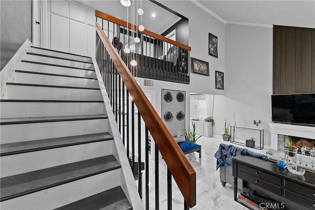 2052 Thomas Pl, West Covina, CA 91792 - stairway featuring marble finish floors, crown molding, a towering ceiling, a fireplace, and recessed lighting
