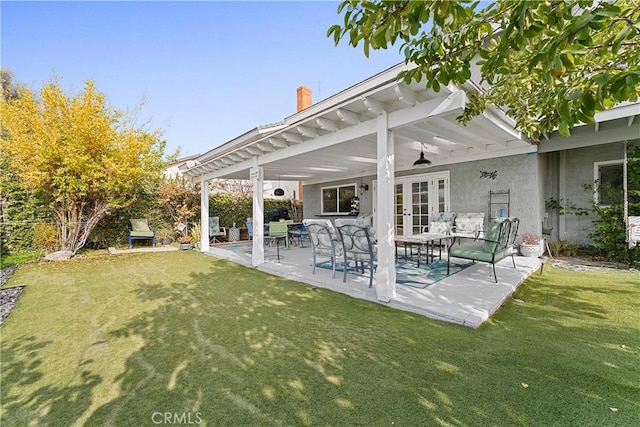 back of house with a yard, ceiling fan, french doors, and a patio