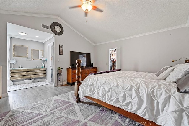 bedroom featuring ceiling fan, crown molding, a textured ceiling, vaulted ceiling, and light wood-type flooring