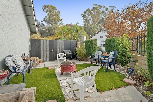 view of yard with a patio and an outdoor fire pit