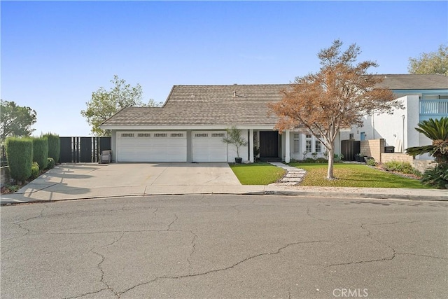 view of front of home with a front yard and a garage