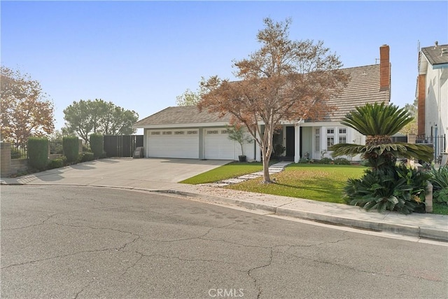 view of front of house with a front yard and a garage