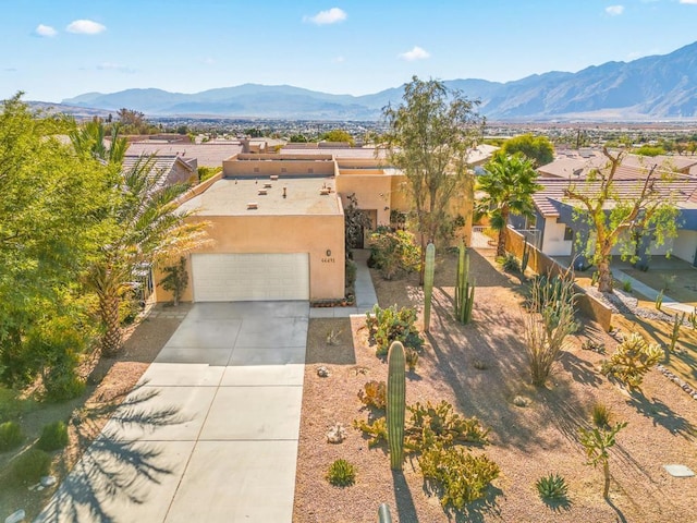 southwest-style home featuring a mountain view and a garage