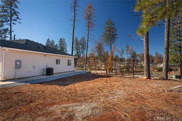 view of yard with a patio and central AC unit