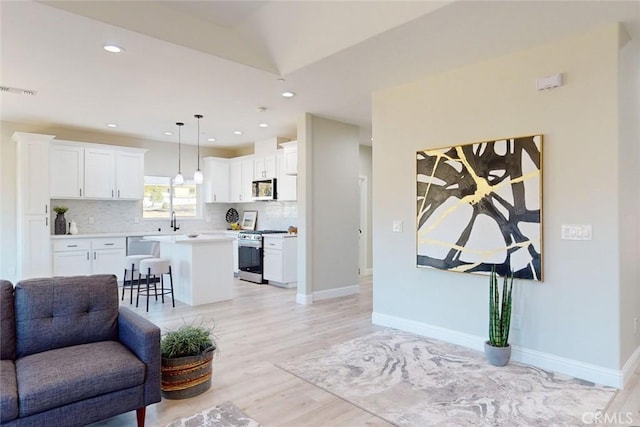 living room featuring light hardwood / wood-style floors and sink