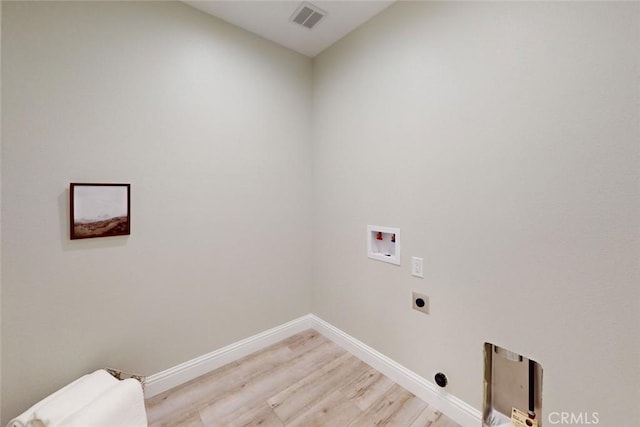 laundry area featuring hookup for a washing machine, light hardwood / wood-style floors, and electric dryer hookup