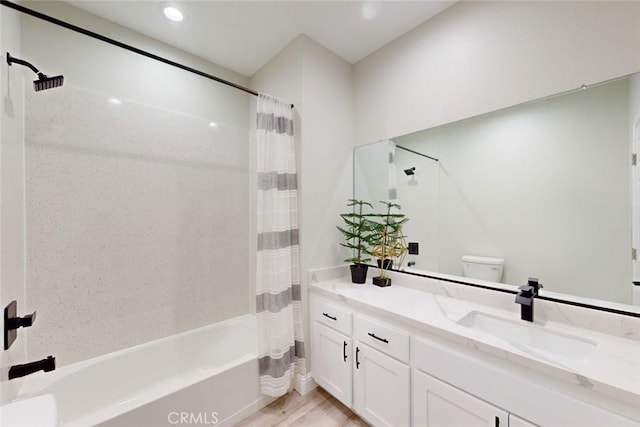 full bathroom featuring toilet, vanity, hardwood / wood-style flooring, and shower / tub combo with curtain