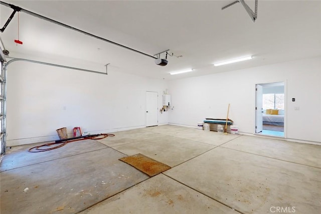 garage featuring water heater and a garage door opener