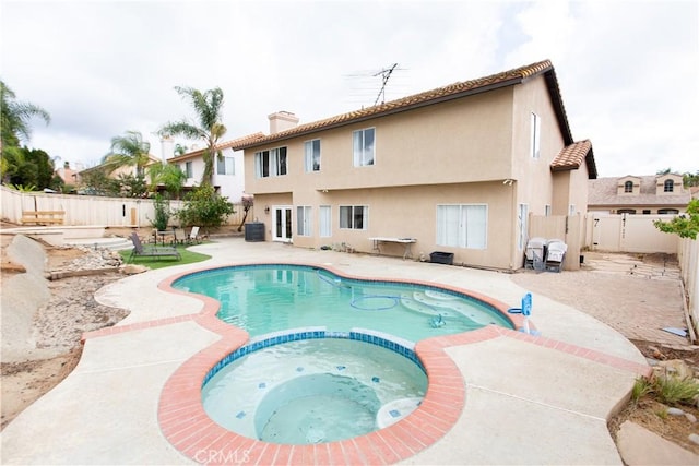 view of swimming pool with an in ground hot tub and a patio