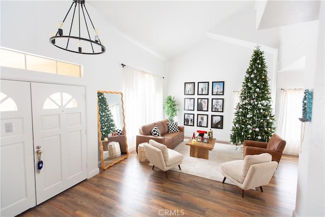 foyer entrance with an inviting chandelier, dark hardwood / wood-style floors, and high vaulted ceiling