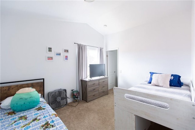 bedroom with lofted ceiling and light carpet