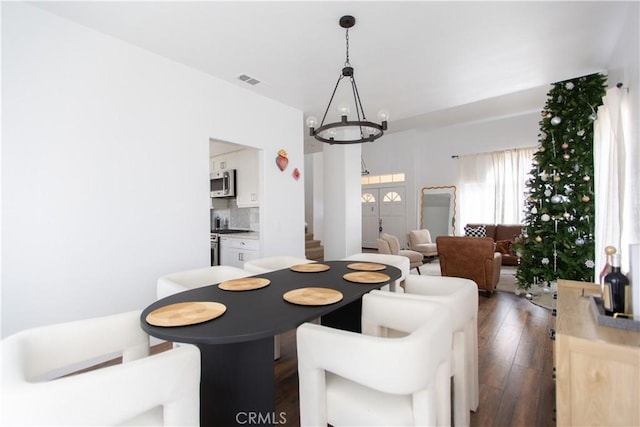 dining room featuring dark hardwood / wood-style floors and a chandelier