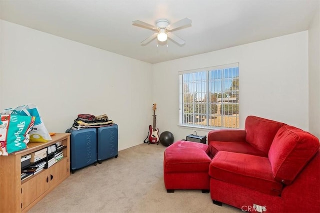 sitting room featuring light carpet and ceiling fan