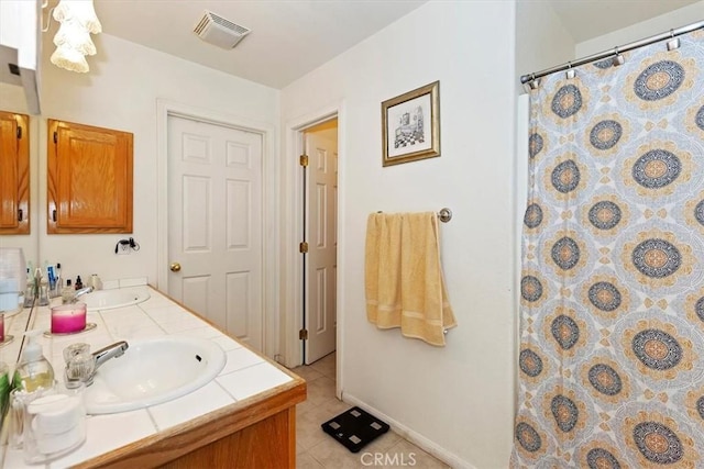 bathroom featuring vanity, tile patterned floors, and curtained shower