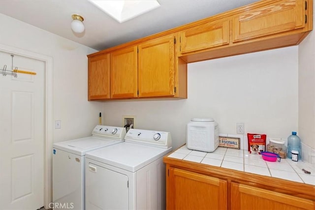 laundry room featuring cabinets and washing machine and clothes dryer