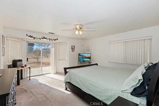 carpeted bedroom with access to exterior and ceiling fan