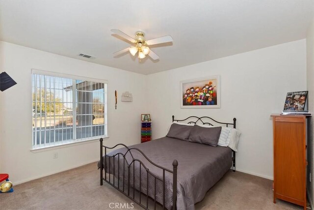 carpeted bedroom with ceiling fan