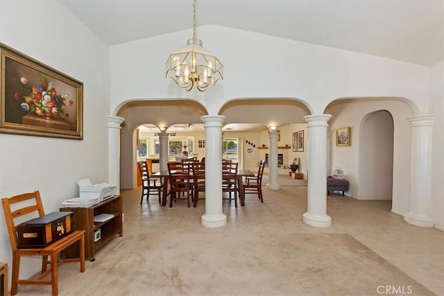 tiled dining area with vaulted ceiling, a notable chandelier, and ornate columns