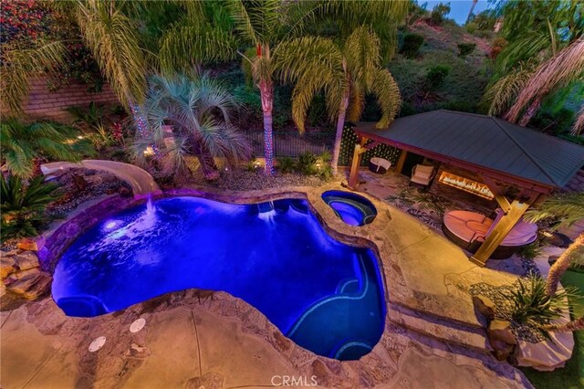 view of swimming pool with a patio area, a gazebo, and an in ground hot tub