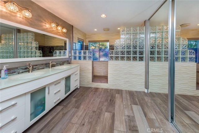 bathroom with hardwood / wood-style flooring and vanity