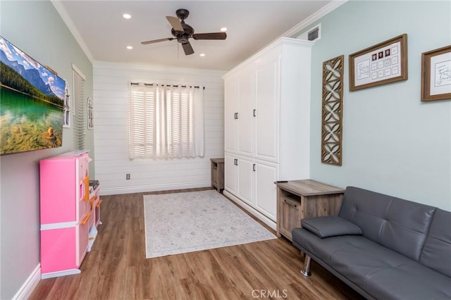 interior space with ceiling fan, dark wood-type flooring, and ornamental molding