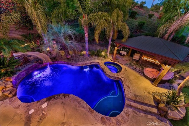 view of pool featuring a patio, an in ground hot tub, a gazebo, and a water slide