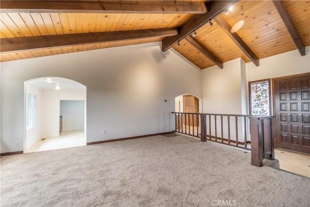 spare room featuring beamed ceiling, wood ceiling, light carpet, and high vaulted ceiling