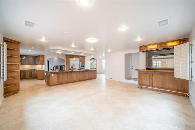 kitchen featuring a center island, stainless steel appliances, and tasteful backsplash