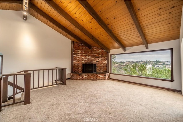 unfurnished living room featuring vaulted ceiling with beams, light colored carpet, a brick fireplace, and wooden ceiling