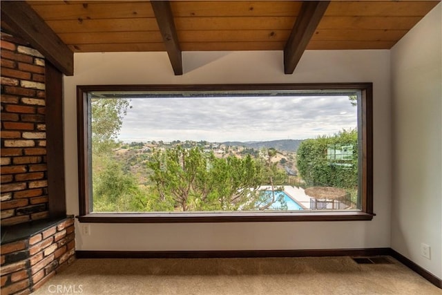 room details with beamed ceiling, carpet floors, and wood ceiling