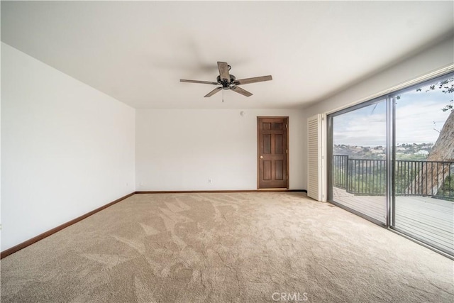 unfurnished room featuring ceiling fan and light carpet