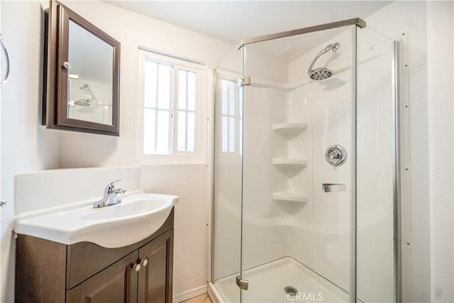 bathroom featuring vanity and a shower with shower door