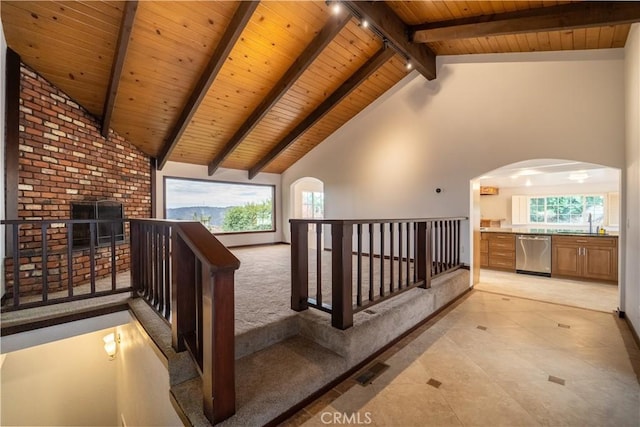 hallway featuring plenty of natural light, high vaulted ceiling, wood ceiling, and beamed ceiling