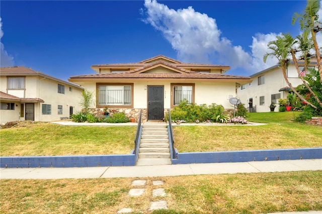 3504 Rainbow Ln, Highland, CA 92346 - view of front of home featuring a tiled roof, a front lawn, stucco siding, and stone siding