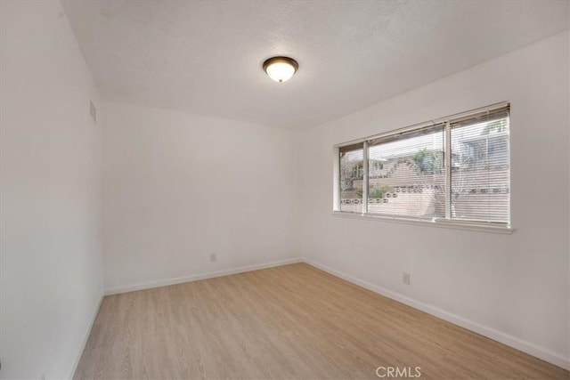 spare room with light wood-type flooring