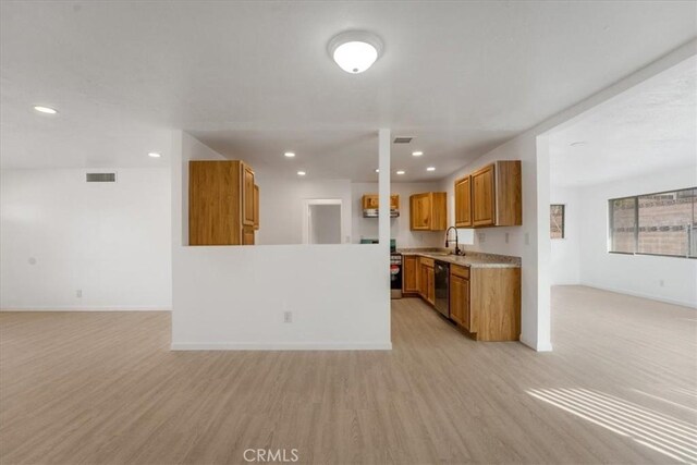 kitchen with sink, light hardwood / wood-style flooring, and black dishwasher