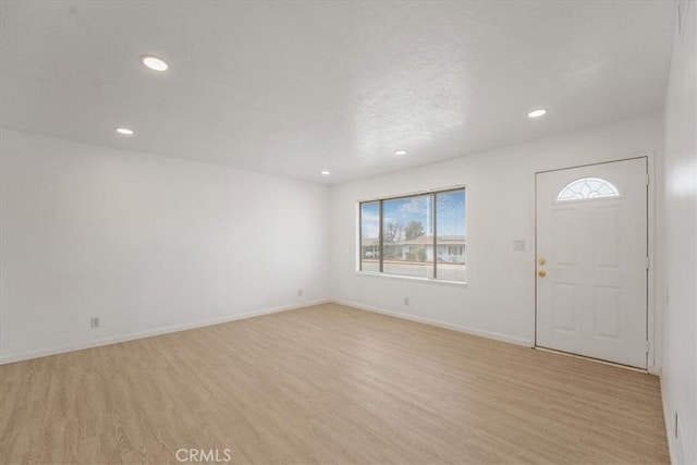 foyer entrance with light hardwood / wood-style floors