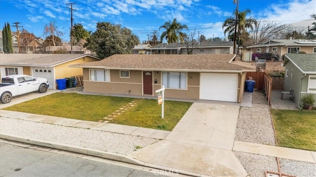 single story home featuring a garage and a front yard